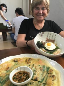 Korean pancakes with green onions, mushrooms and shrimp are among my favorite dishes. You eat them with chopsticks and dip them in soy sauce. Yum!