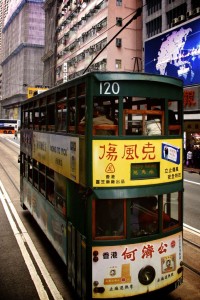 There are lots of trams in Hong Kong. Notice how it runs on a track like a train, but it looks like a bus.